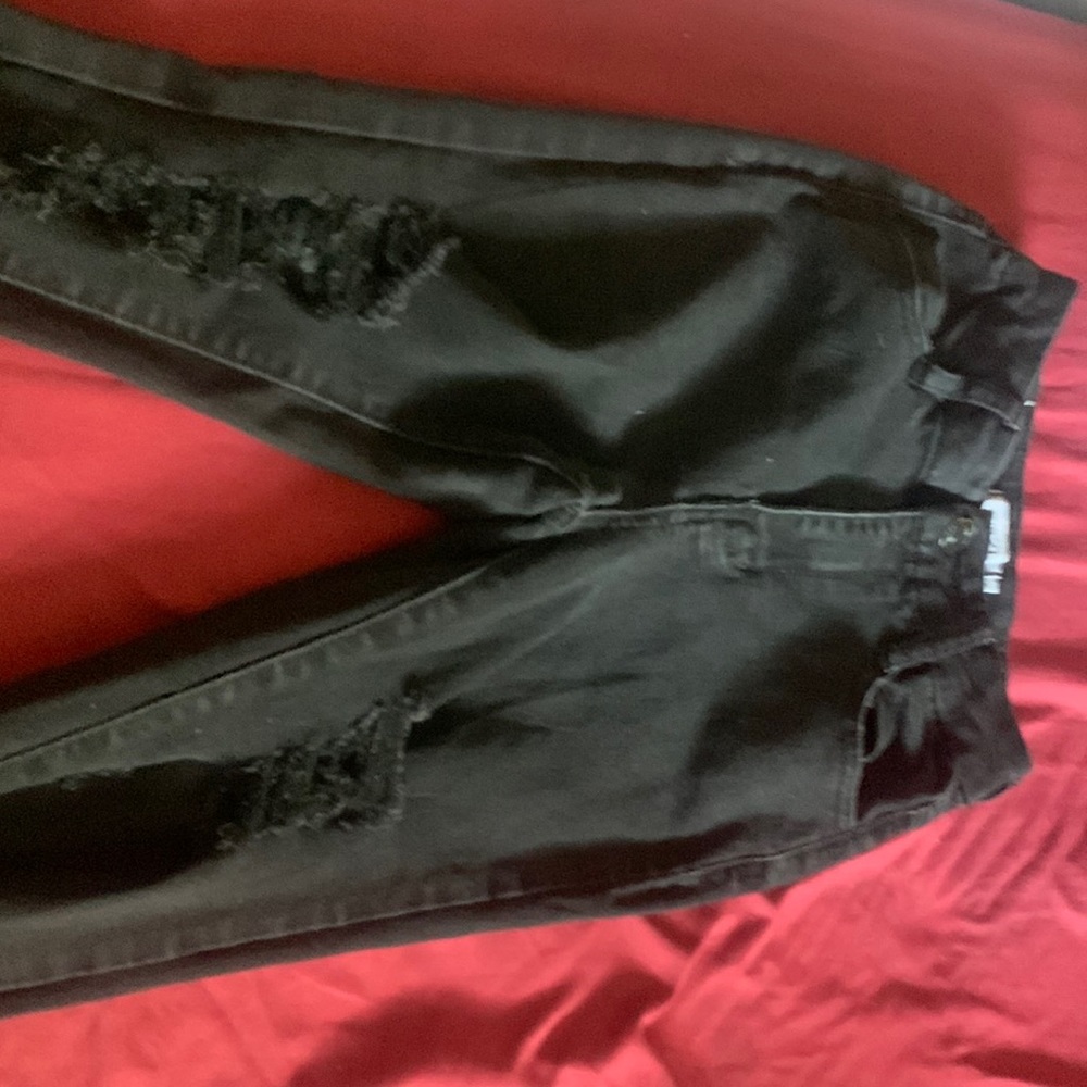 A pair of slightly loved black jeans, size 0 in juniors